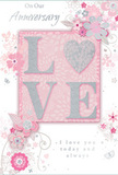 This anniversary card design is a tender celebration of enduring romance, its soft pastel pinks, silvery greys, and pearly whites combining to create an atmosphere of cherished intimacy, much like a quiet evening walk through Valentines Park in Ilford. At the centre, the word LOVE is proudly displayed in softly raised glitter letters, each stroke refined and luminous. The O is replaced by a shimmering silver heart, slightly more textured than the surrounding letters, giving a sense of depth and inviting the fingertips to linger. Around this central emblem, delicate blooms in blush, mauve, and light ivory unfurl with a watercolour softness, their petals formed by fine, flowing lines that suggest careful attention rather than rigid formality. Slender vines and swirling tendrils weave between the flowers, while tiny butterflies and curved flourishes bring movement and whimsy to the layout, recalling the grace of an English spring garden just opening to the season. The gentle phrases On Our Anniversary and I love you today and always are written in an elegant, lightly slanted script, nestled into the design as naturally as a message tucked into a bouquet from a local Ilford florist. The overall composition feels balanced and serene, with enough negative space to let each floral element breathe. Subtle hints of silver catch the light, suggesting celebration without overwhelming the card's soft, heartfelt mood. This design appears perfectly suited to sit alongside a hand-delivered anniversary arrangement, marking a shared journey in Ilford with quiet yet deeply felt emotion.